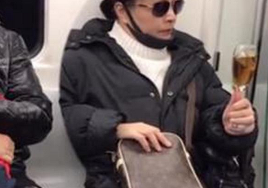 大妈乘地铁戴墨镜举酒杯不戴口罩,你在地铁上见过行为举止夸张的人吗?
